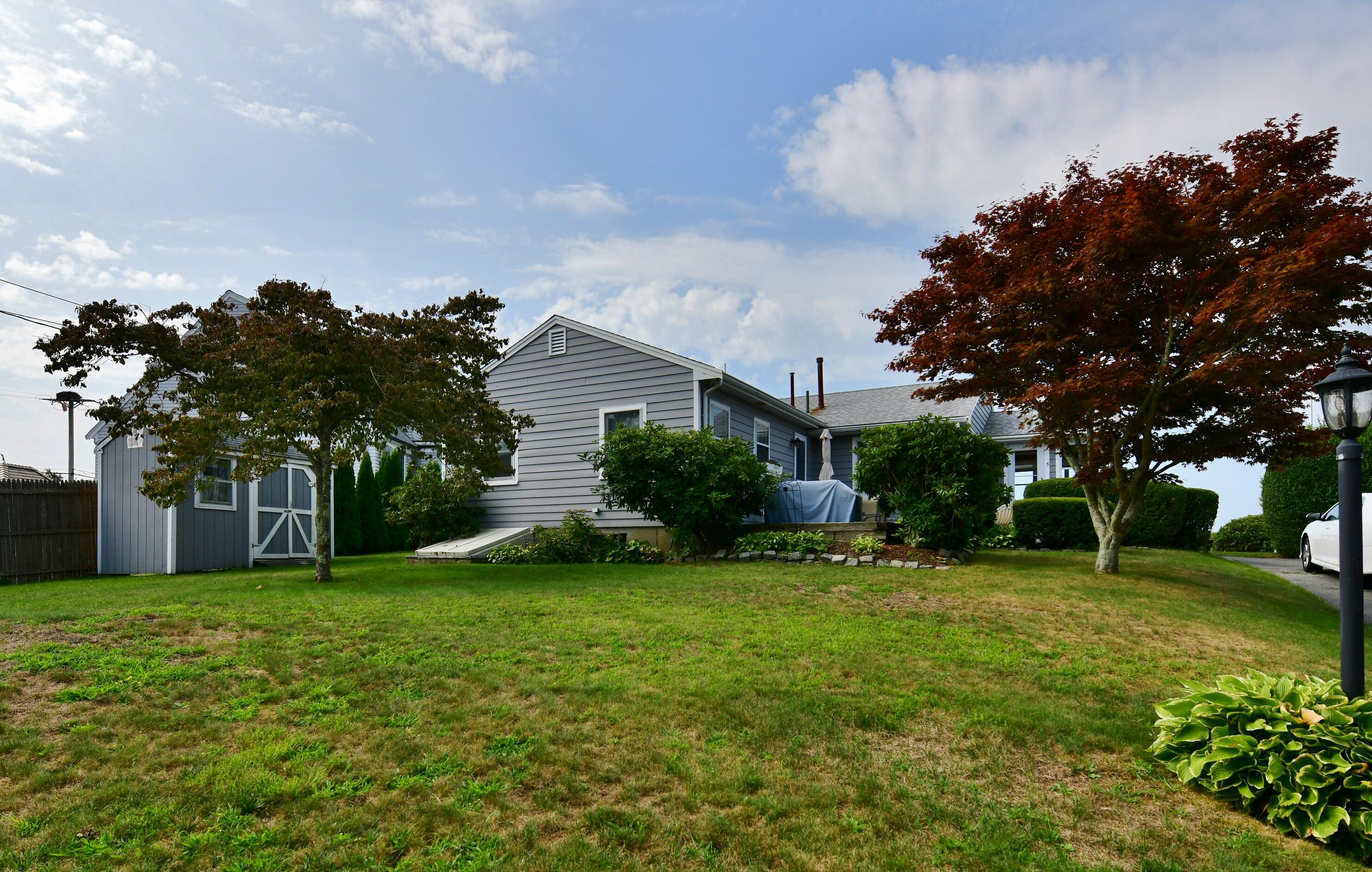5 Spindrift Lane, Unit WINTER Buzzards Bay, MA 02532 - Photo 9 of 34 a view of a house with a big yard and palm trees