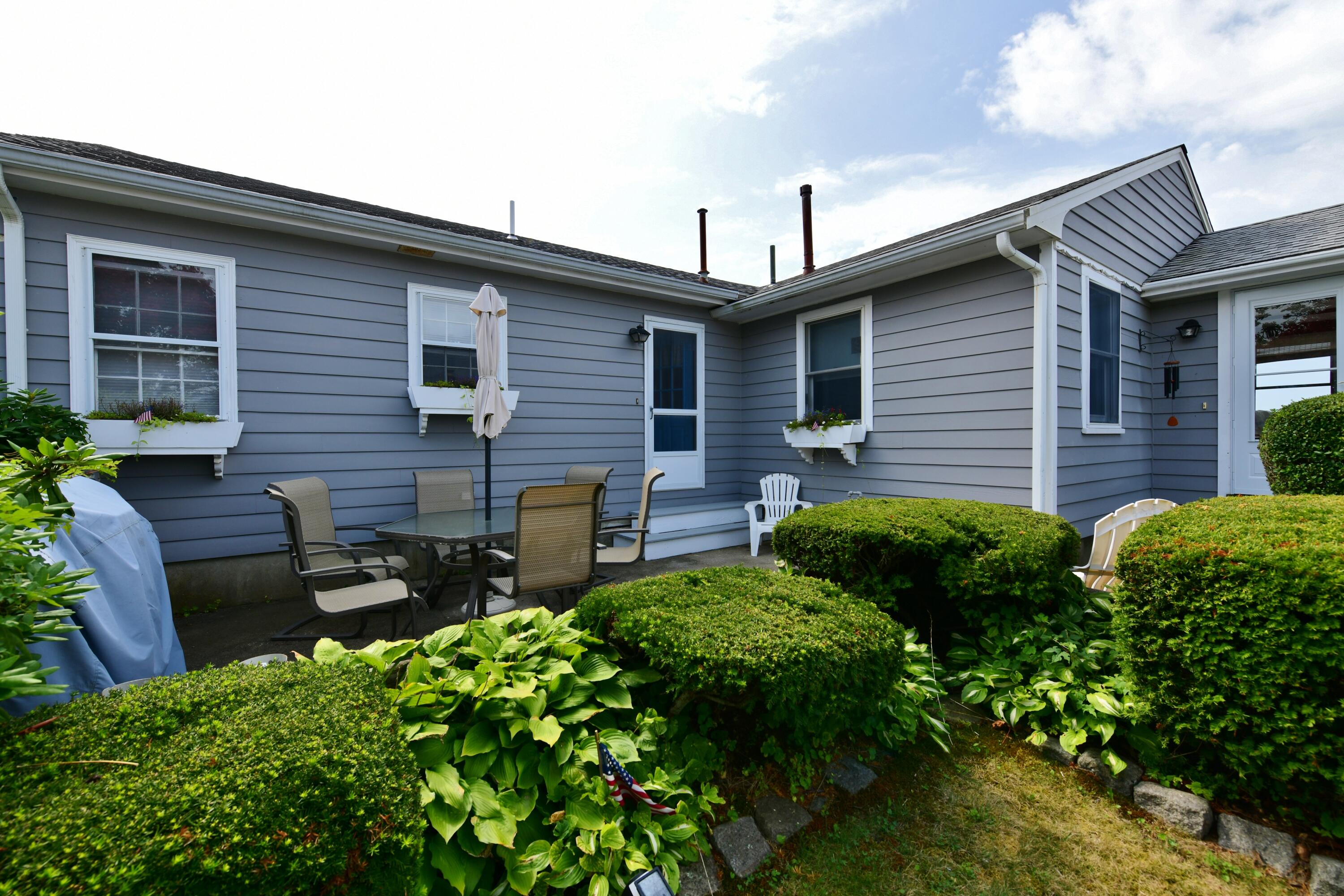 5 Spindrift Lane, Unit WINTER Buzzards Bay, MA 02532 - Photo 10 of 34 a backyard of a house with seating space