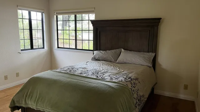 a bedroom with a bed and window