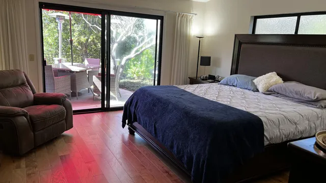 a bedroom with a bed couch and window