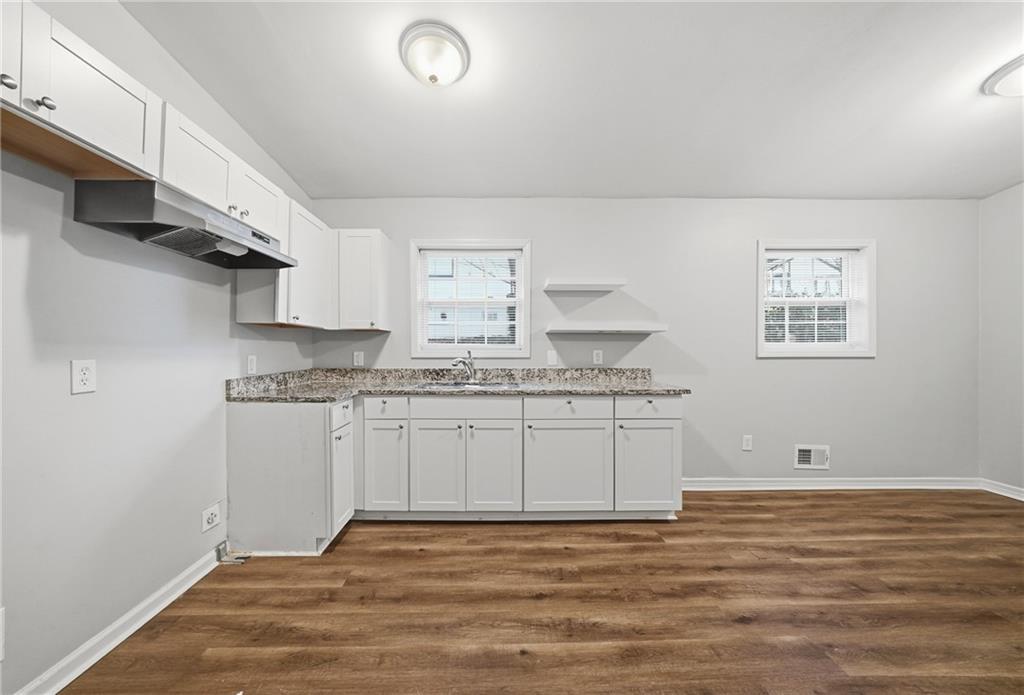 3024 Pasadena Drive Decatur, GA 30032 - Photo 12 of 28 a kitchen with granite countertop white cabinets and white appliances
