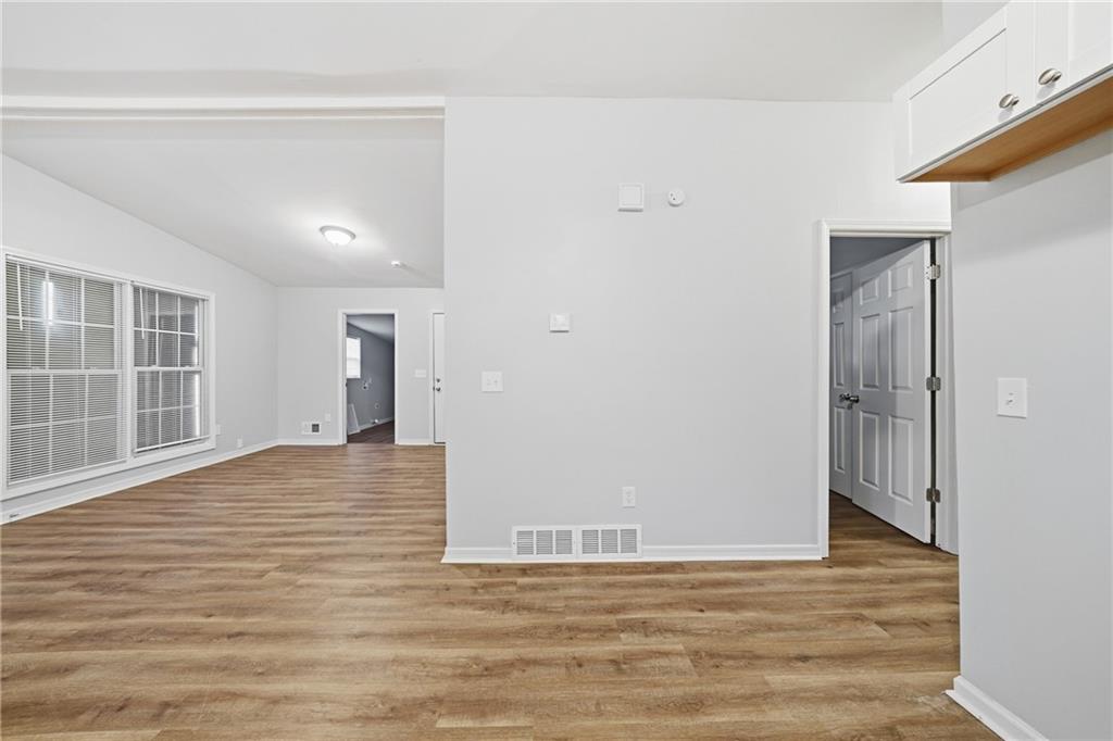 3024 Pasadena Drive Decatur, GA 30032 - Photo 13 of 28 a view of an empty room with wooden floor and a window