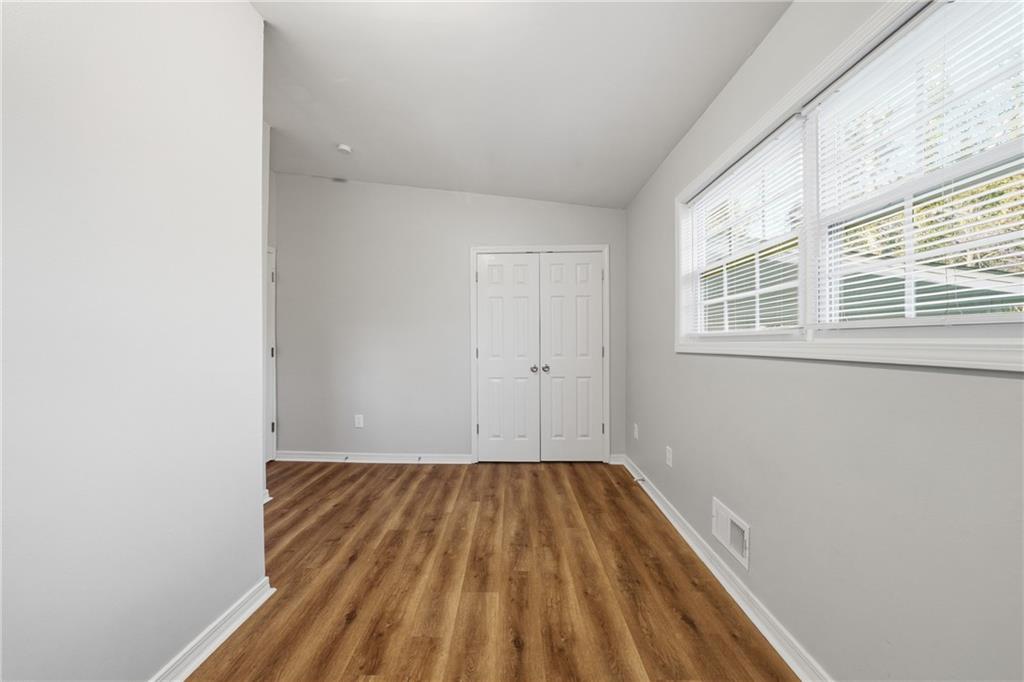 3024 Pasadena Drive Decatur, GA 30032 - Photo 17 of 28 a view of a room with wooden floor and brick walls