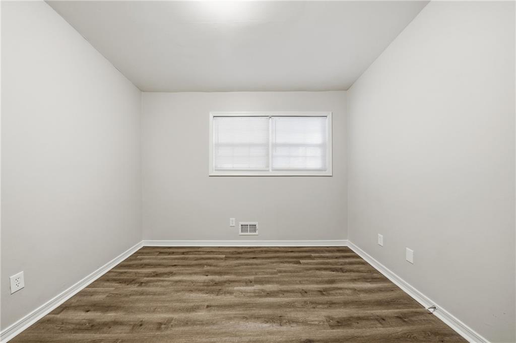 3024 Pasadena Drive Decatur, GA 30032 - Photo 19 of 28 an empty room with wooden floor and window