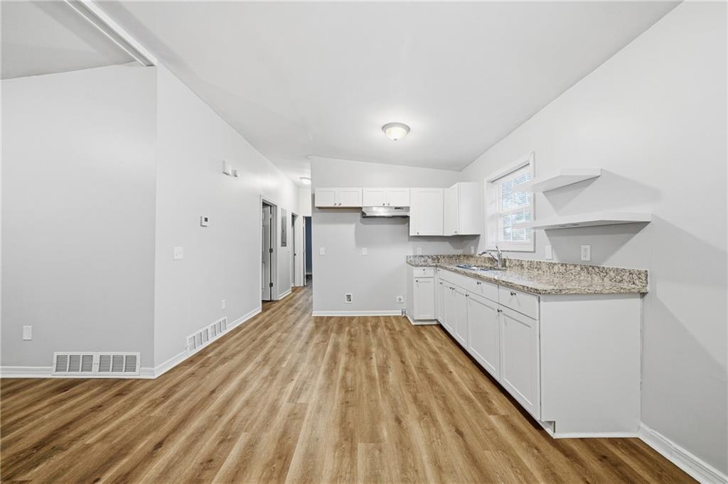 3024 Pasadena Drive Decatur, GA 30032 - Photo 10 of 28 a kitchen with granite countertop white cabinets and white appliances