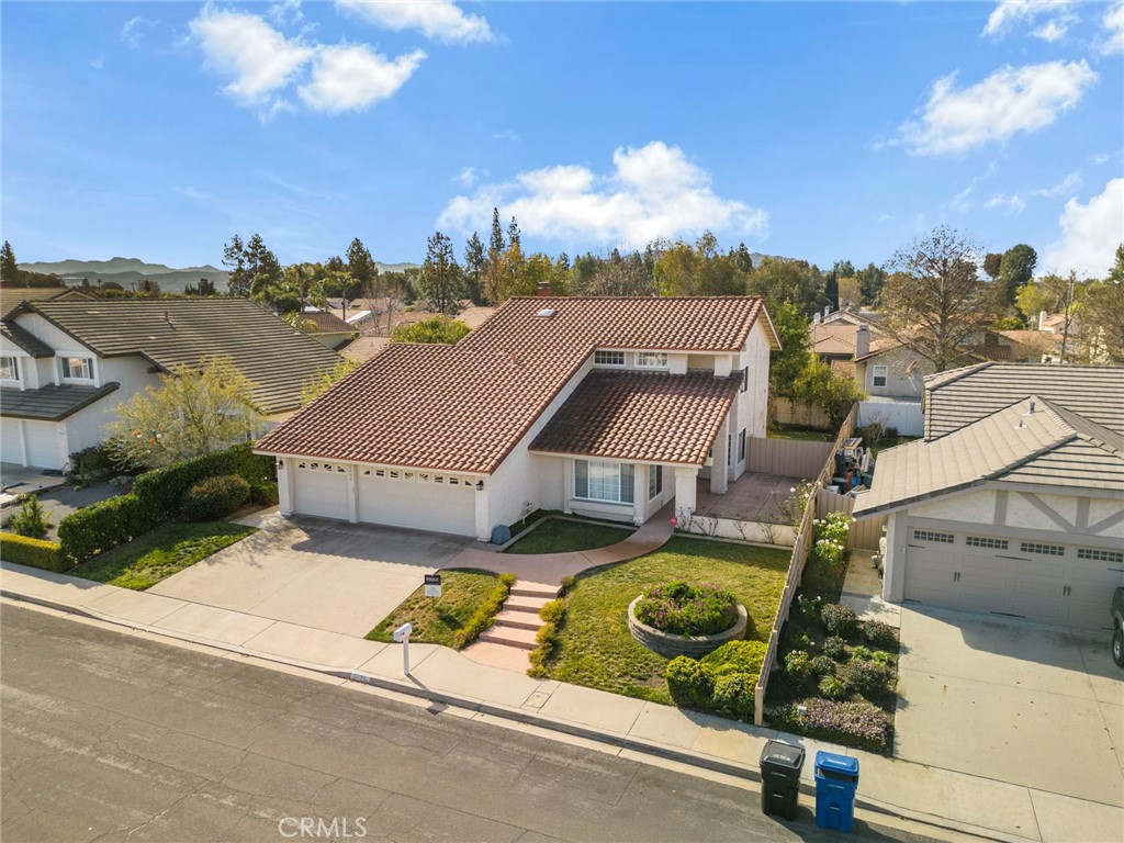 an aerial view of a house with a garden and lake view