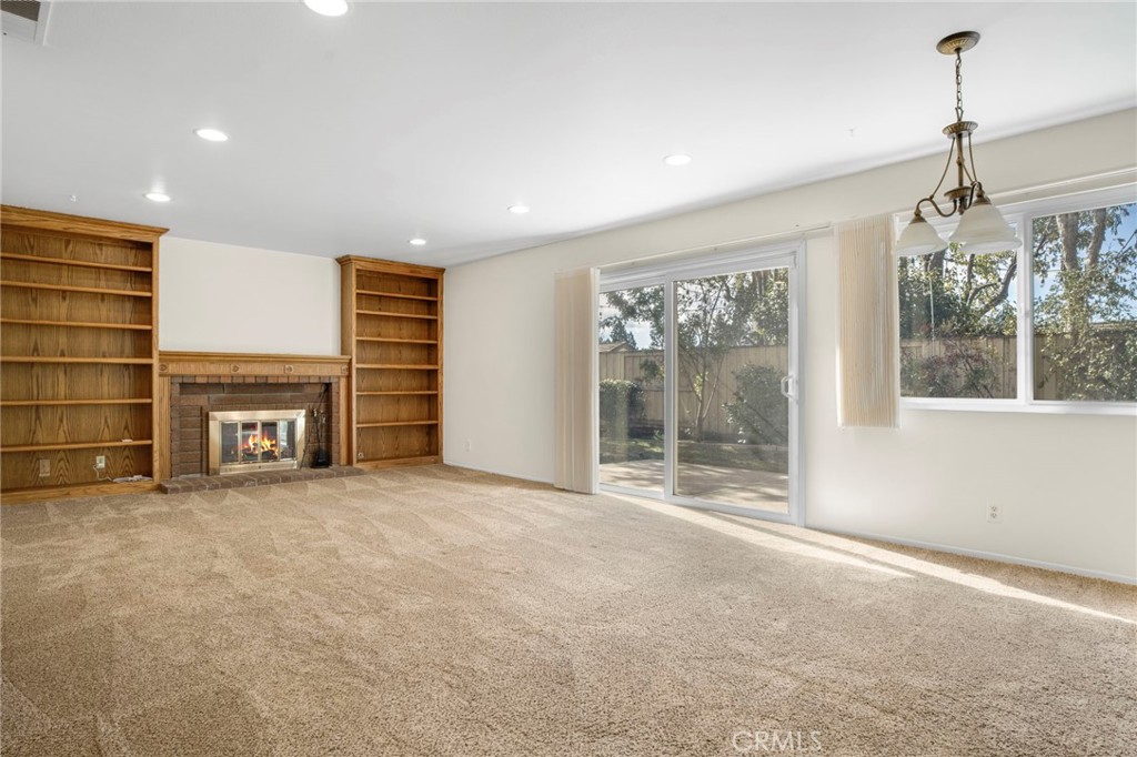 3488 Radcliffe Road Thousand Oaks, CA 91360 - Photo 11 of 23 a view of an empty room with a fireplace and a window