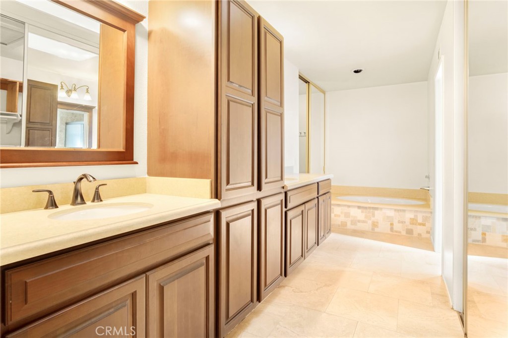 3488 Radcliffe Road Thousand Oaks, CA 91360 - Photo 16 of 23 a bathroom with a granite countertop sink and a large mirror