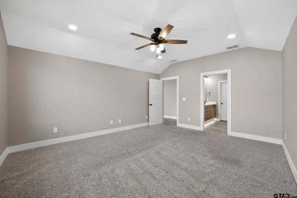 a view of an empty room with a ceiling fan
