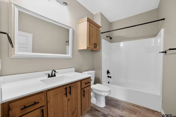 a bathroom with a sink mirror toilet and bathtub