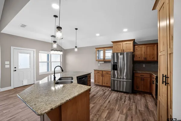a kitchen with kitchen island a counter top space appliances and cabinets