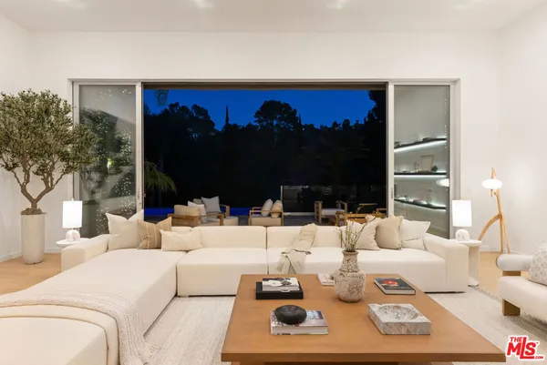 a living room with furniture lamp and flat screen tv