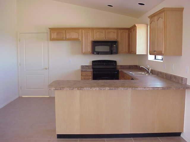 247 Paseo Mascota Rio Rico, AZ 85648 - Photo 3 of 3 a kitchen with stainless steel appliances a microwave a sink and cabinets