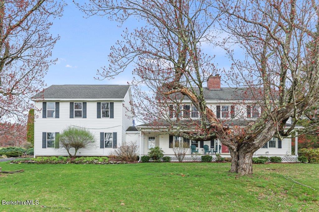 10 Goodell Road Lanesborough, MA 01237 - Photo 2 of 67 a view of a white house next to a yard with big trees