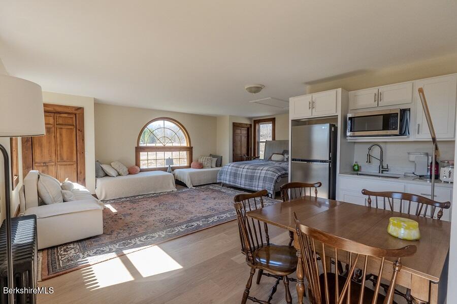10 Goodell Road Lanesborough, MA 01237 - Photo 26 of 67 a living room with furniture dining table and a refrigerator