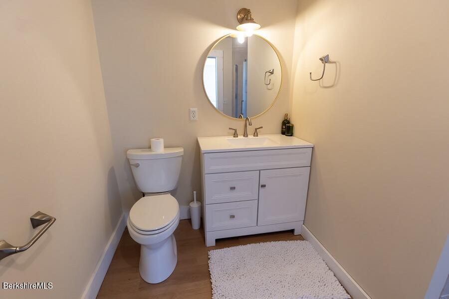 10 Goodell Road Lanesborough, MA 01237 - Photo 29 of 67 a bathroom with a toilet a sink and mirror