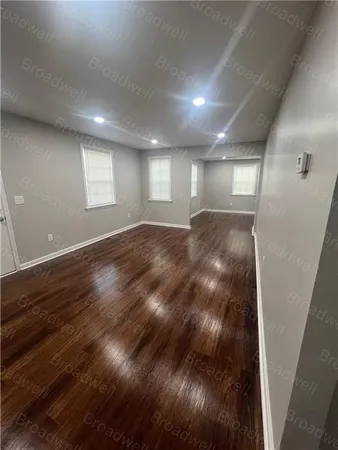 a view of a room with wooden floor and white walls
