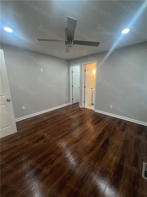 1860 Broadwell Street Southwest Atlanta, GA 30310 - Photo 17 of 23 an empty room with wooden floor and windows
