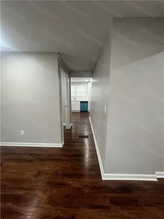 a view of a hallway and wooden floor