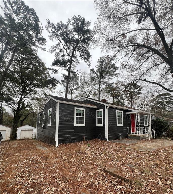 1860 Broadwell Street Southwest Atlanta, GA 30310 - Photo 2 of 23 a front view of a house with a garden