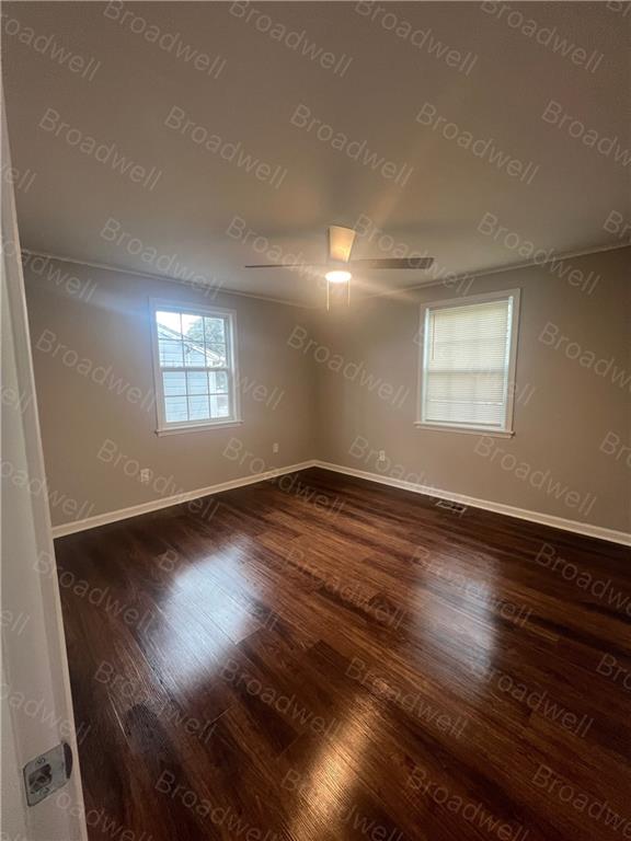 1860 Broadwell Street Southwest Atlanta, GA 30310 - Photo 21 of 23 an empty room with wooden floor and windows