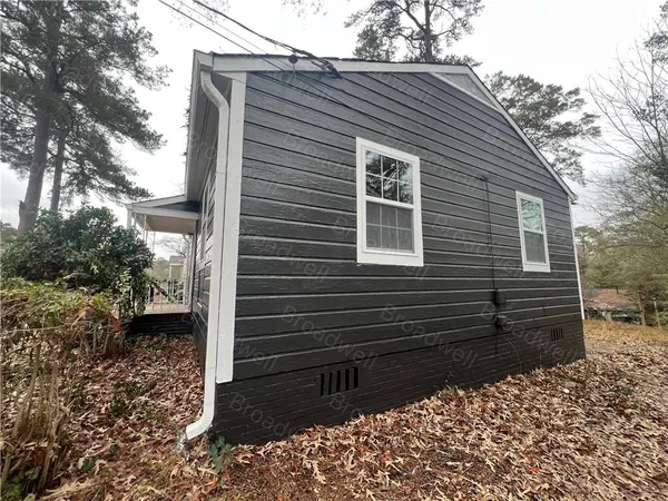 a back view of a house with a yard