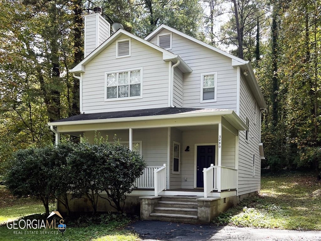 a view of a house with a yard and plants