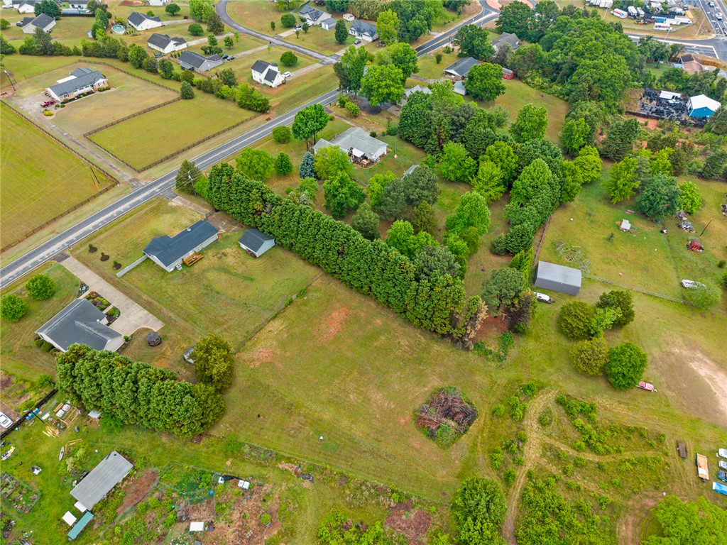 4508 Old Williamston Road Belton, SC 29627 - Photo 46 of 47 This expansive property features mature trees and open fields, offering a peaceful country setting.