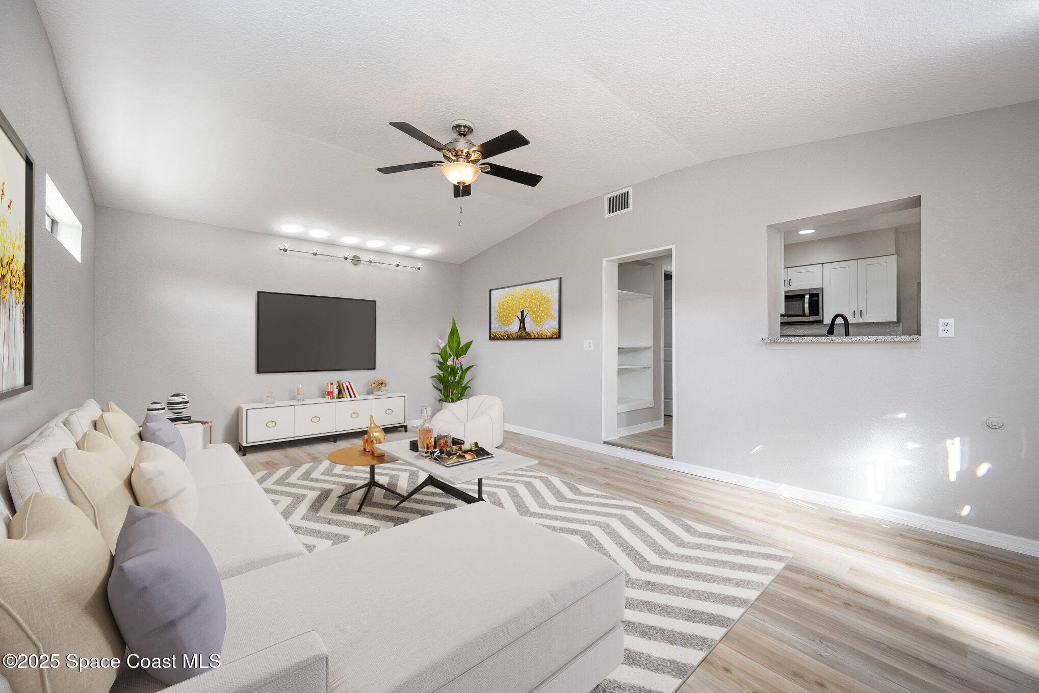 980 Miracle Way Rockledge, FL 32955 - Photo 12 of 33 a living room with furniture and a flat screen tv
