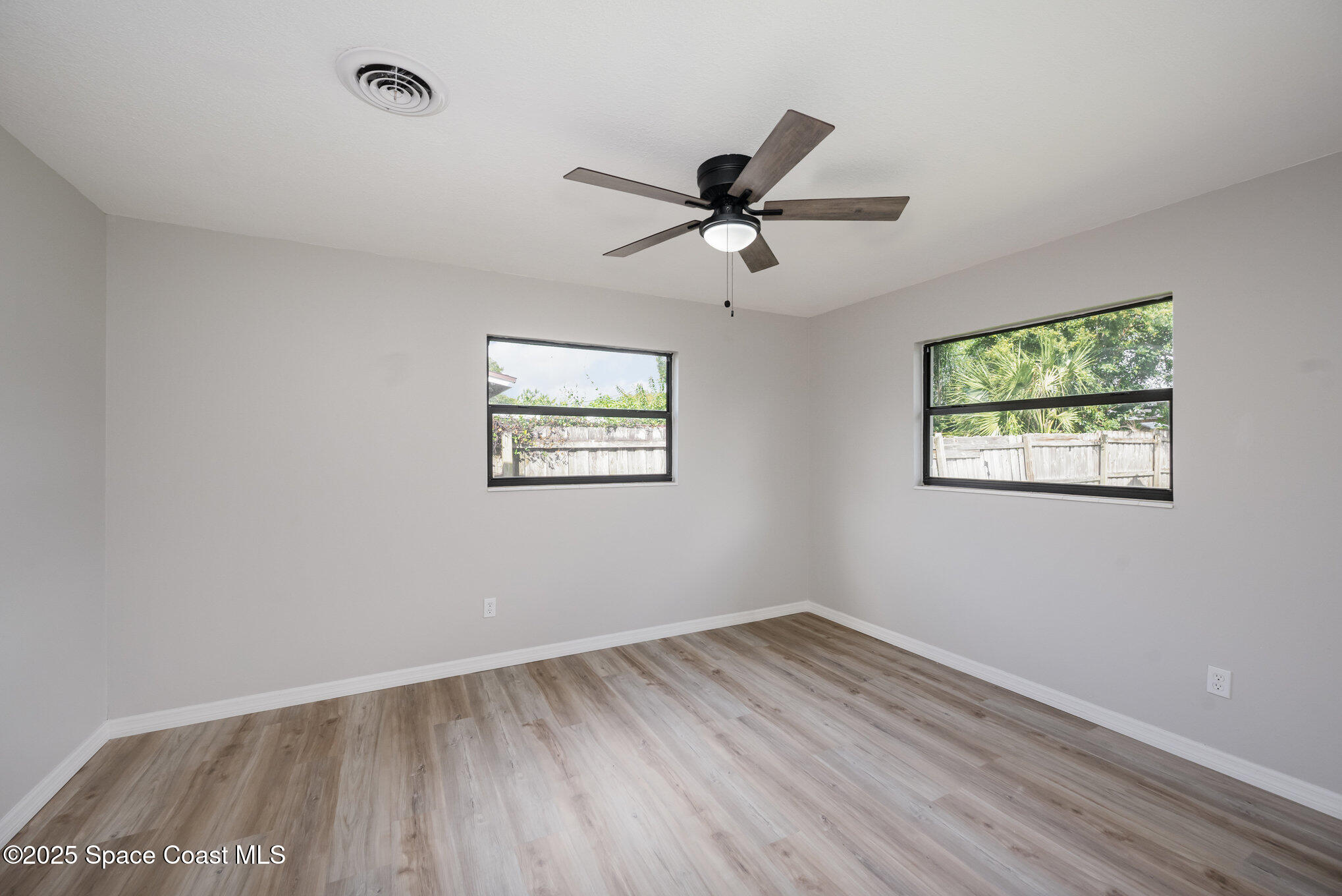 980 Miracle Way Rockledge, FL 32955 - Photo 15 of 33 a view of empty room with wooden floor and fan