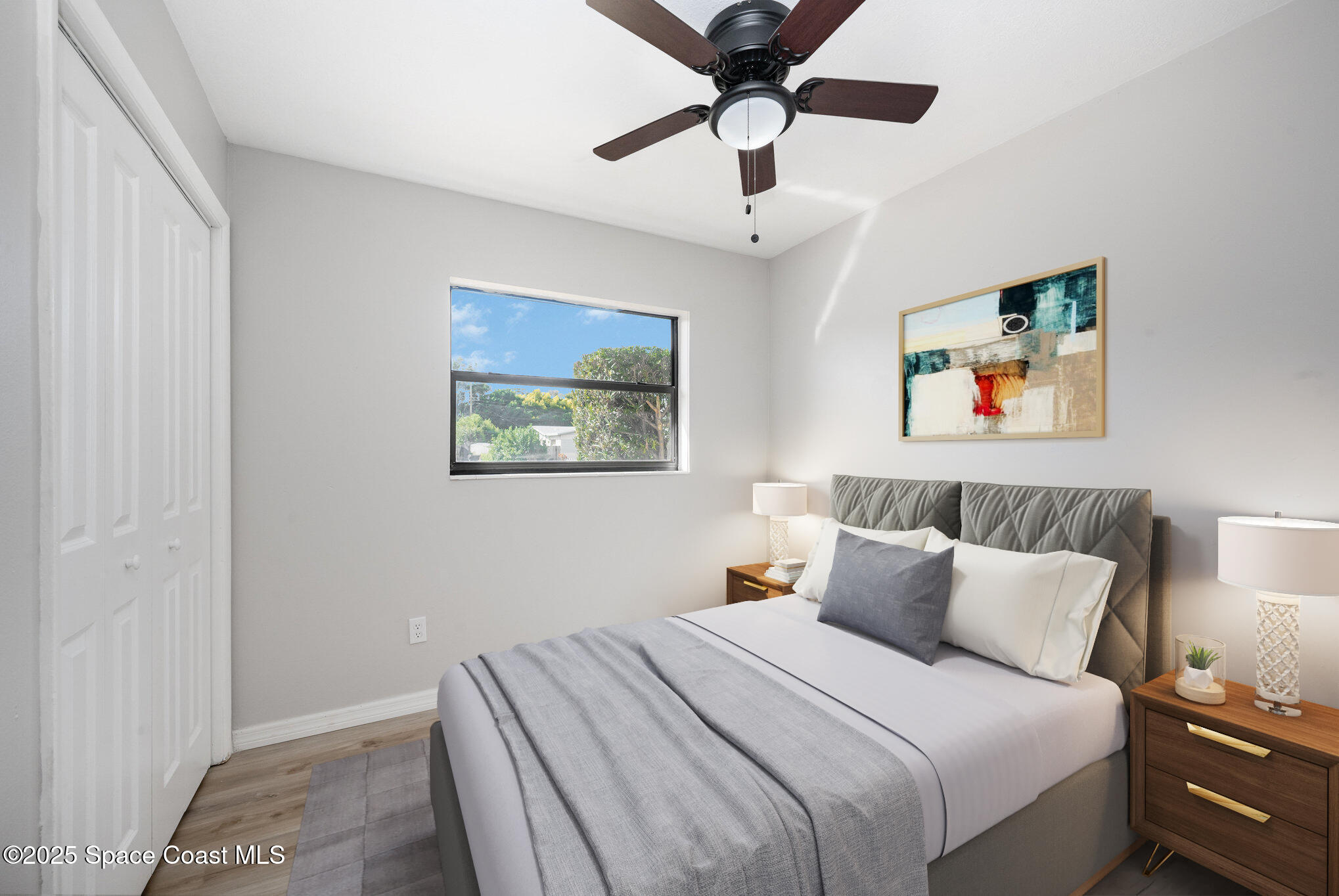 980 Miracle Way Rockledge, FL 32955 - Photo 21 of 33 a bedroom with a large bed and a chandelier