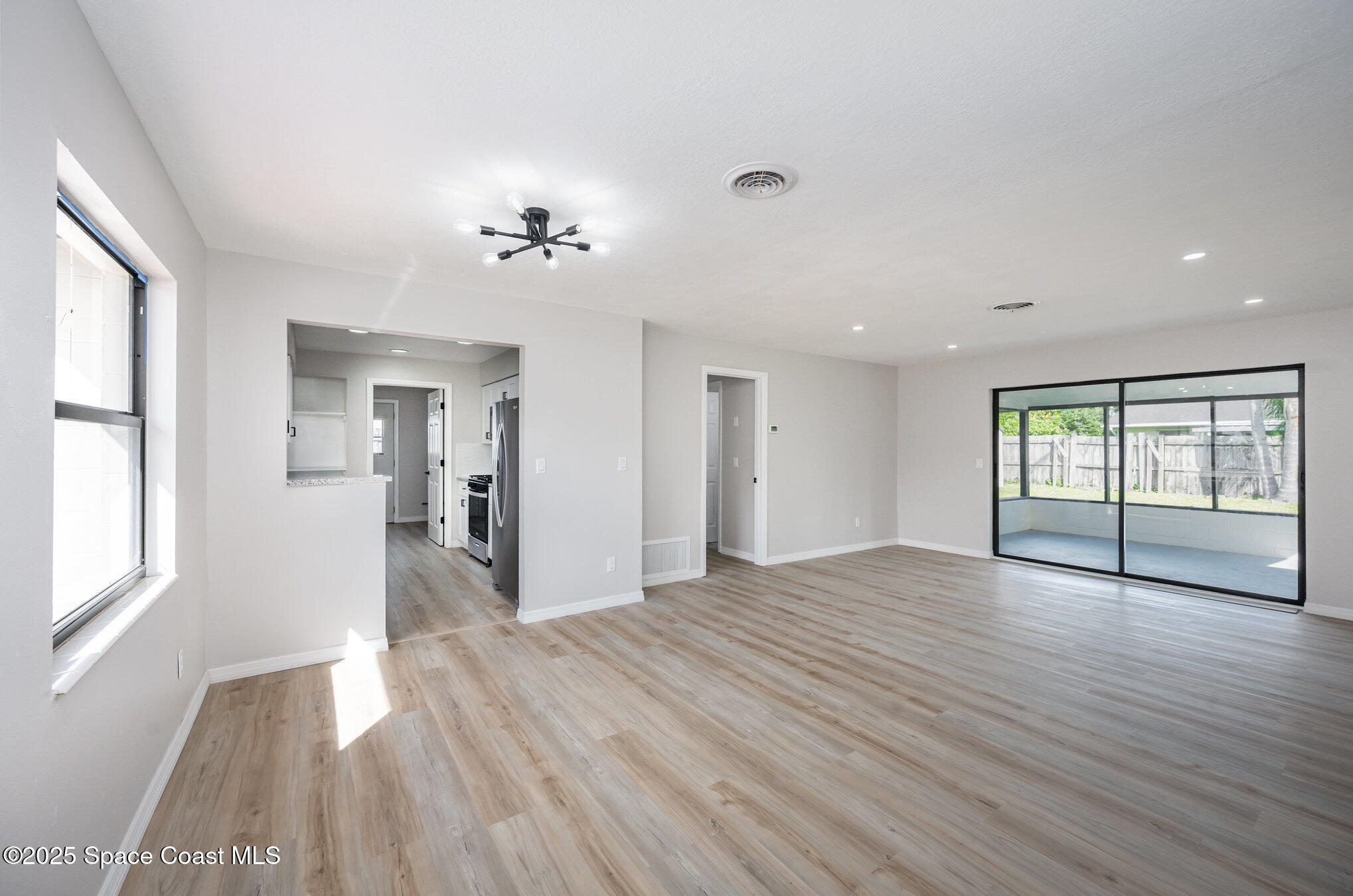 980 Miracle Way Rockledge, FL 32955 - Photo 6 of 33 a view of empty room with wooden floor and fan