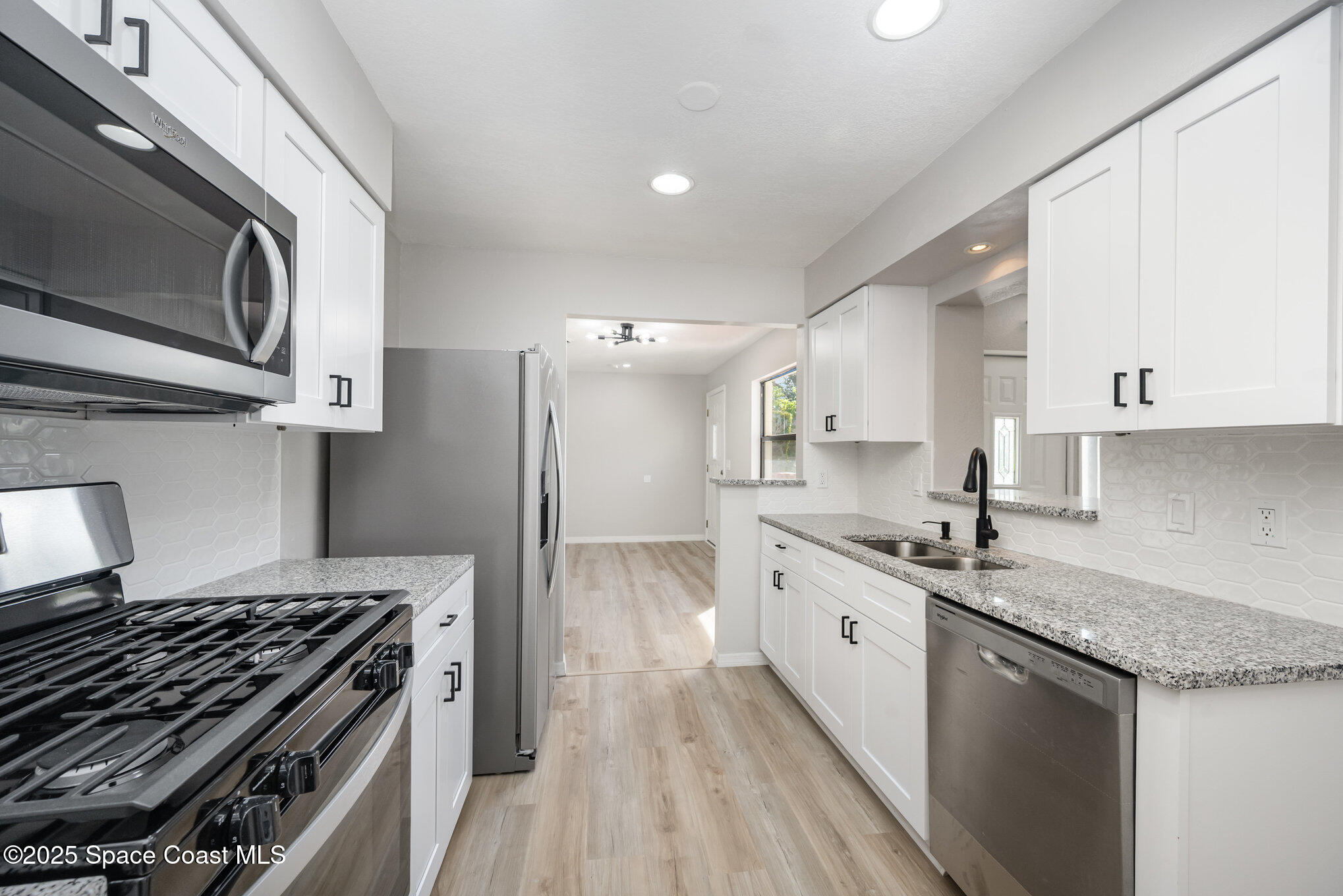 980 Miracle Way Rockledge, FL 32955 - Photo 10 of 33 a kitchen with a stove oven and sink
