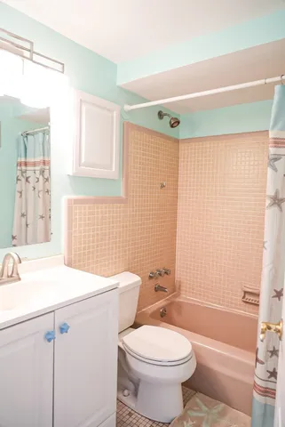 a bathroom with a sink a toilet and shower curtain