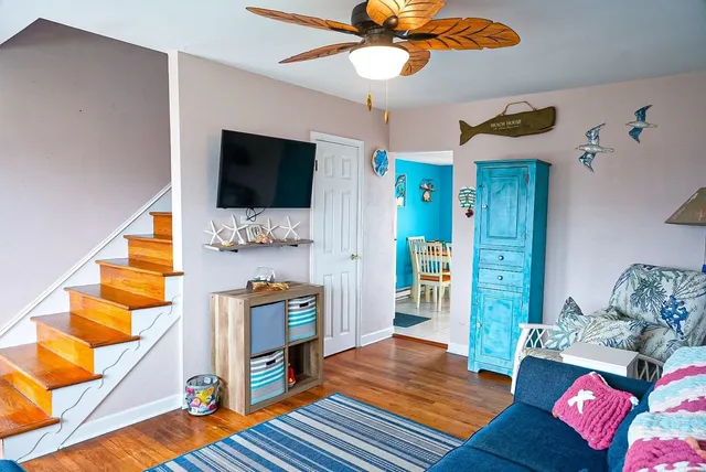 a living room with furniture and a flat screen tv