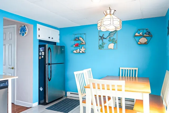 a dining room with furniture a rug and a chandelier