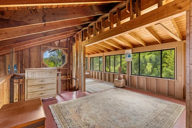 a view of a room with furniture and windows