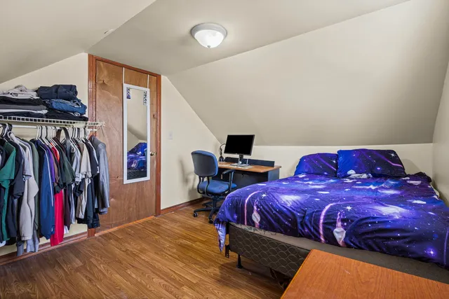 a bedroom with a bed and a view of walk in closet