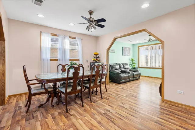 a view of a dining room with furniture window and wooden floor