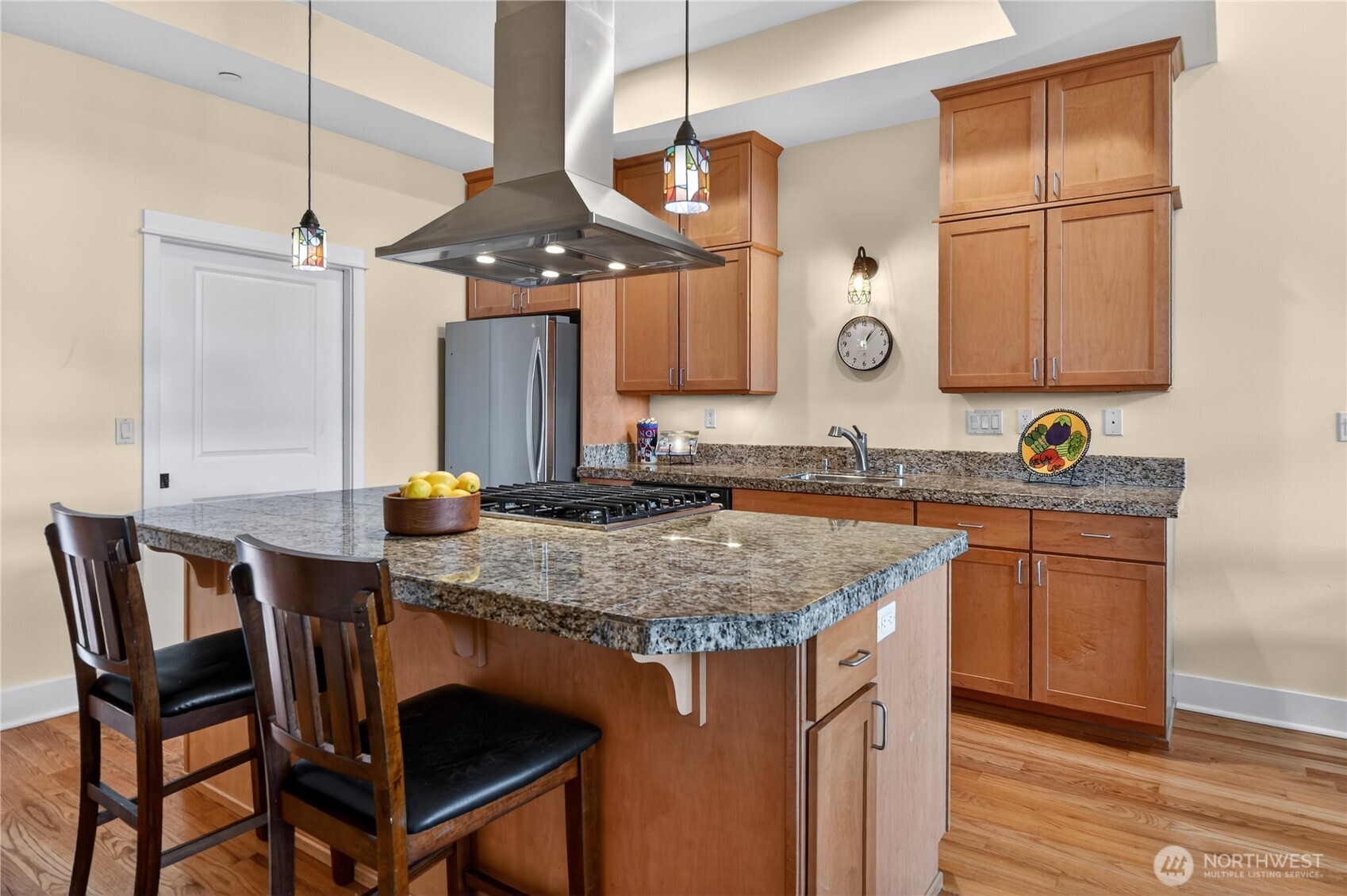383 Romance Hill Road, Unit C Belfair, WA 98528 - Photo 6 of 25 a kitchen with a table chairs sink and cabinets