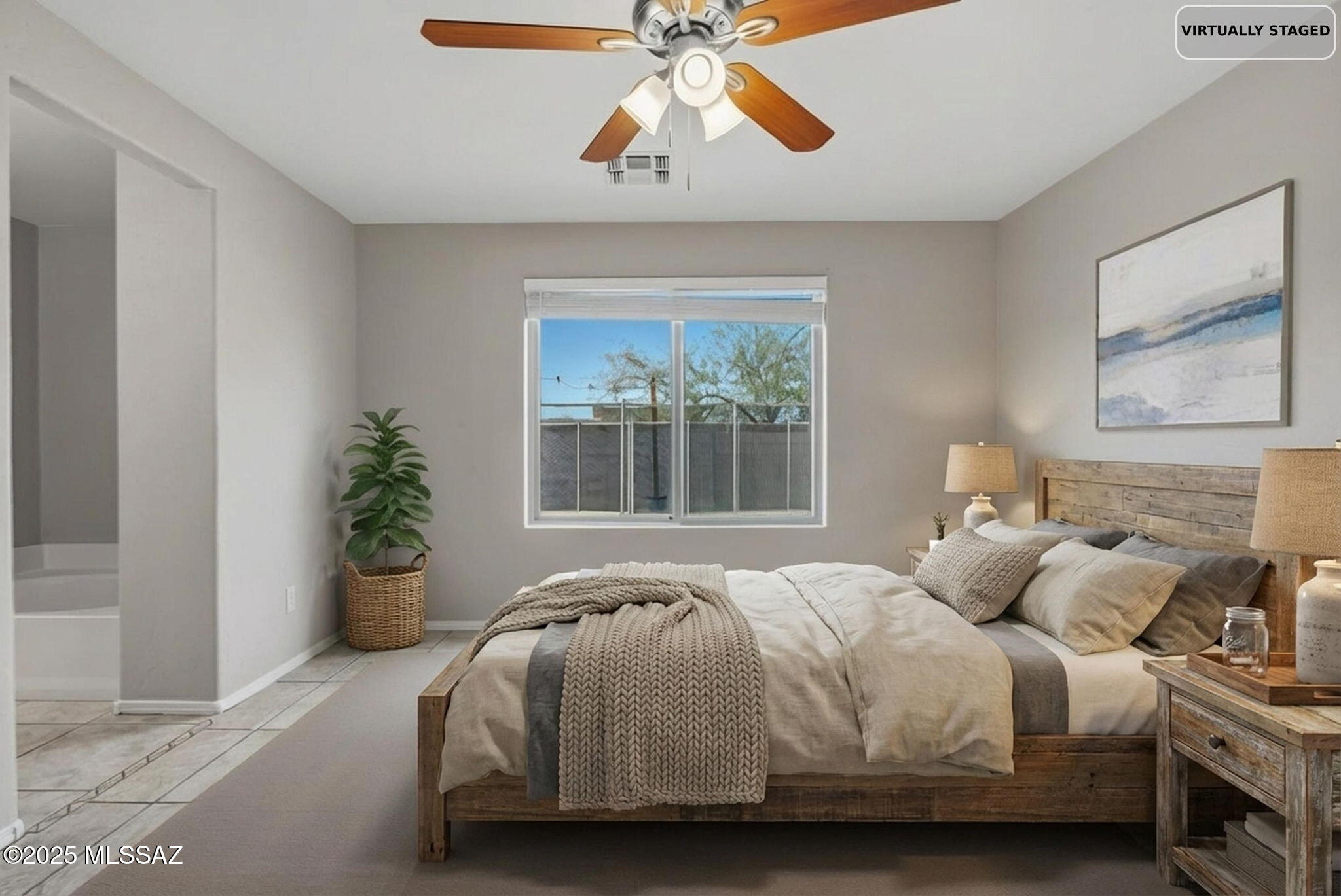 8244 South Lost Mountain Road Tucson, AZ 85747 - Photo 16 of 41 a bedroom with a bed and a chandelier