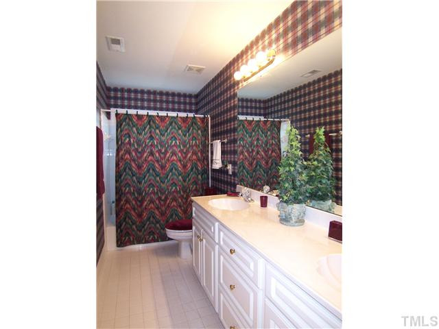 9101 Kettner Court Raleigh, NC 27615 - Photo 22 of 25 The lg hall Bath features dbl sinks and tiled floor & tub/shower. Bathroom
