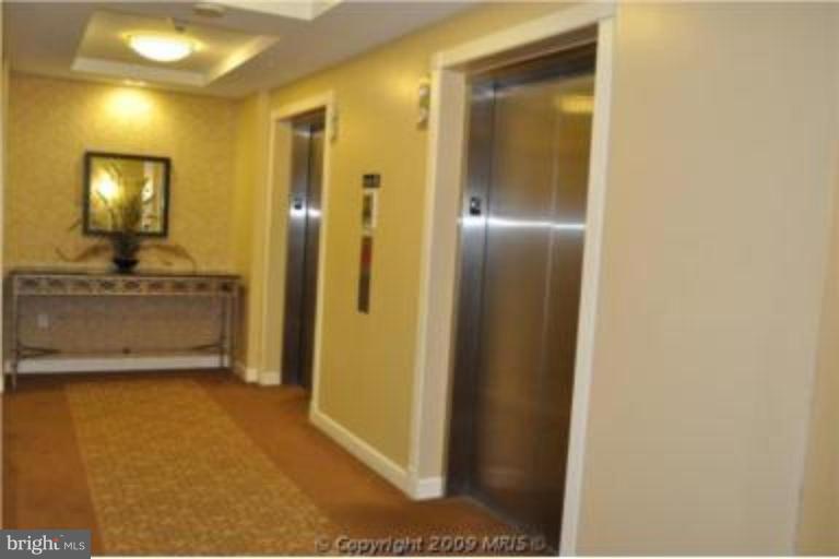2726 Gallows Road, Unit 1416 Vienna, VA 22180 - Photo 20 of 22 a view of a hallway with wooden floor