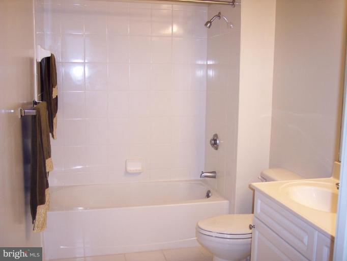 2726 Gallows Road, Unit 1416 Vienna, VA 22180 - Photo 8 of 22 a bathroom with a granite countertop bathtub shower sink vanity and toilet