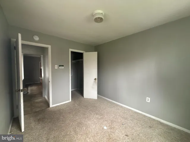 an empty room with closet area
