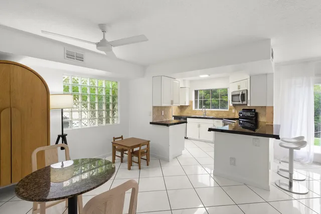 a kitchen with stainless steel appliances granite countertop a sink and a stove