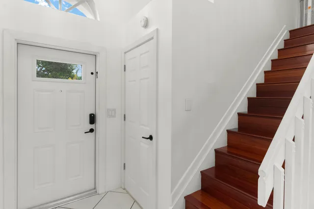 a bathroom with a granite countertop toilet sink and mirror