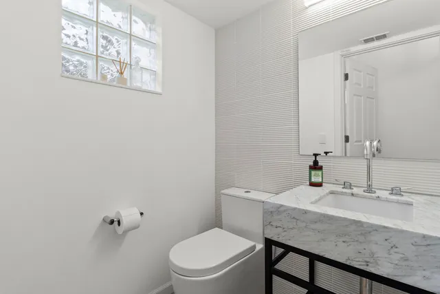 a spacious bedroom with a large bed and a flat screen tv