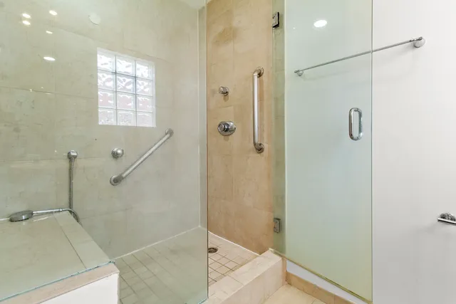 a bedroom with a bed table chair and a window