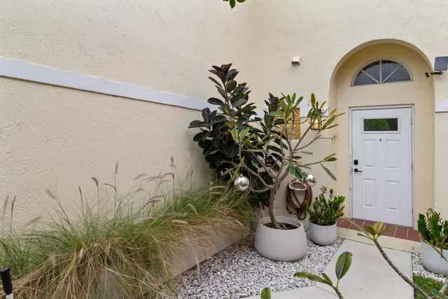 a vase of flowers sitting on a table with potted plant